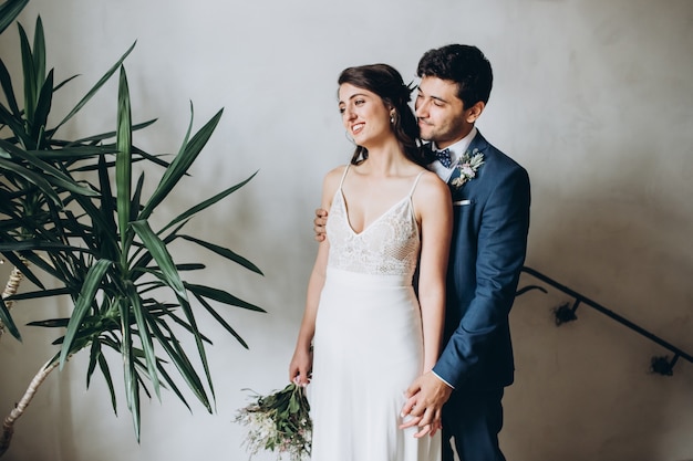 Elegant bride and groom posing together outdoors