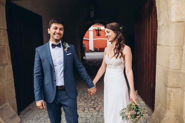 Elegant bride and groom posing together outdoors