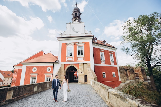 Elegant bride and groom posing together outdoors