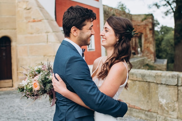 Elegant bride and groom posing together outdoors