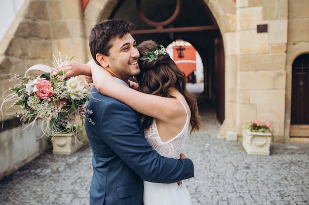 Elegant bride and groom posing together outdoors