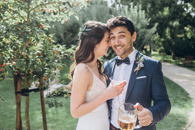 Elegant bride and groom posing together outdoors