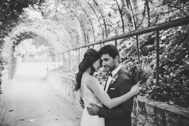 Elegant bride and groom posing together outdoors