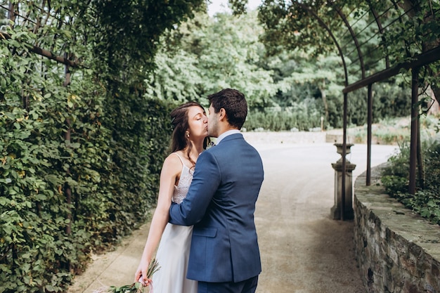 Elegant bride and groom posing together outdoors