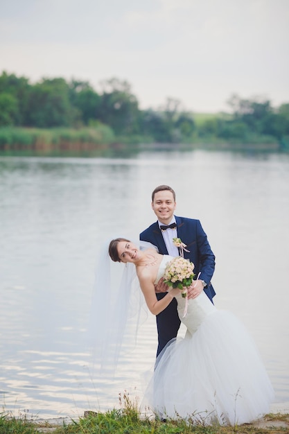 Elegant bride and groom posing together outdoors