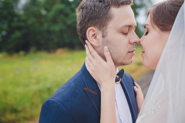 Elegant bride and groom posing together outdoors