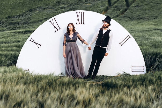 Elegant bride and groom walking and posing on green field