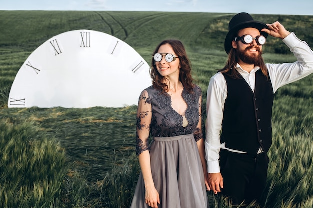 Elegant bride and groom walking and posing on green field