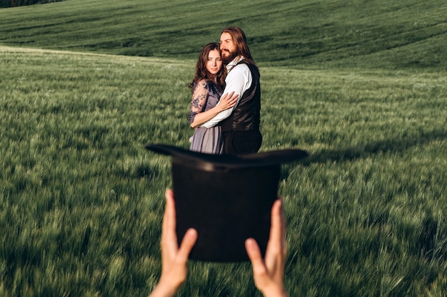 Elegant bride and groom walking and posing on green field