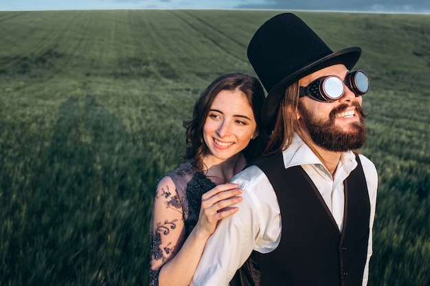 Elegant bride and groom walking and posing on green field