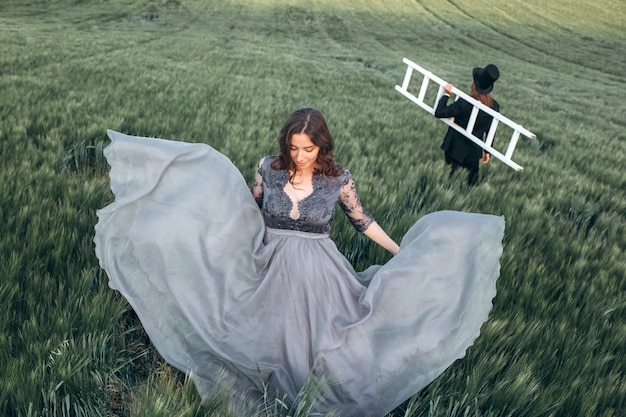 Elegant bride and groom walking and posing on green field