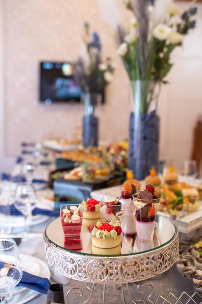 Elegant catering display with sweet and savory treats on mirrored tray