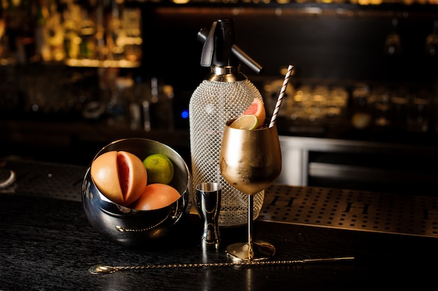 Elegant copper glass filled with sweet summer cocktail with fruit