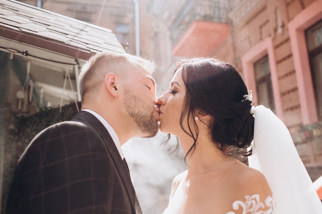 Elegant couple walking at sunset, love story, portrait of bride and groom on wedding day