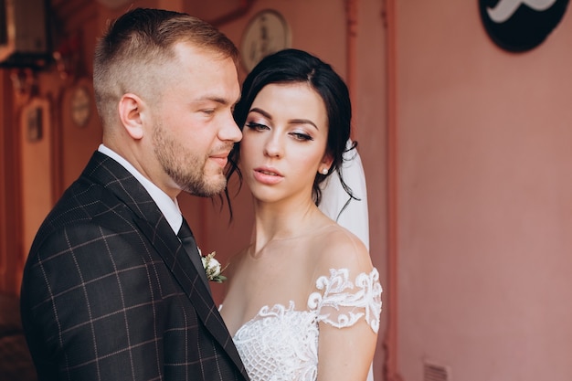 Elegant couple walking at sunset, love story, portrait of bride and groom on wedding day