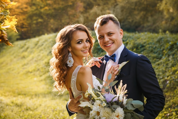 Elegant curly bride and stylish groom