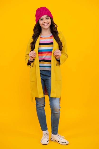 Elegant fashion teenager child girl posing in studio Trends kids clothes Happy teenager positive and smiling emotions of teen girl