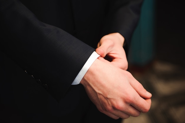 Elegant groom dressing in a wedding suit