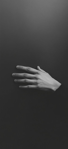 Photo elegant human hand against dark background minimalist art and gesture