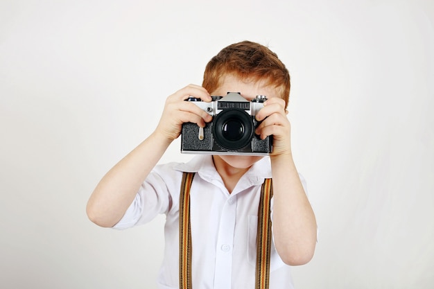 Elegant little photographer with braces and analogue film photocamera