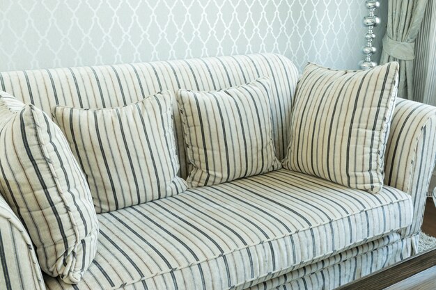 Photo elegant living room interior with striped pattern pillows on sofa