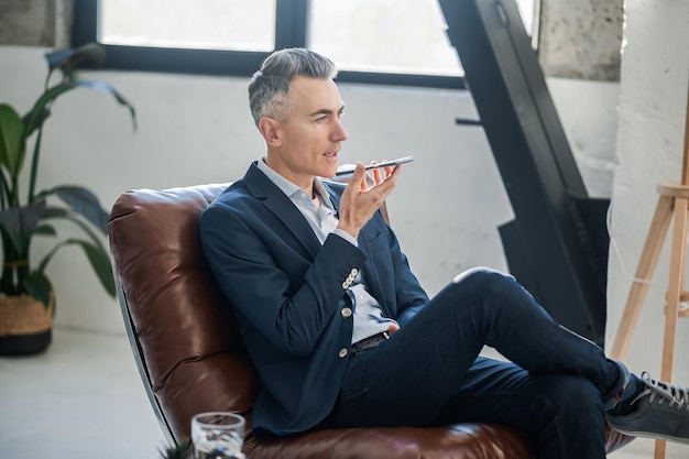 Elegant man with a smartphone in hands