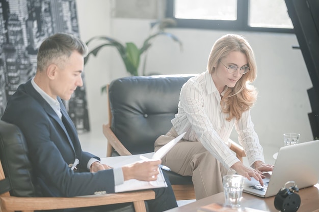 Elegant man and woman working together in the office