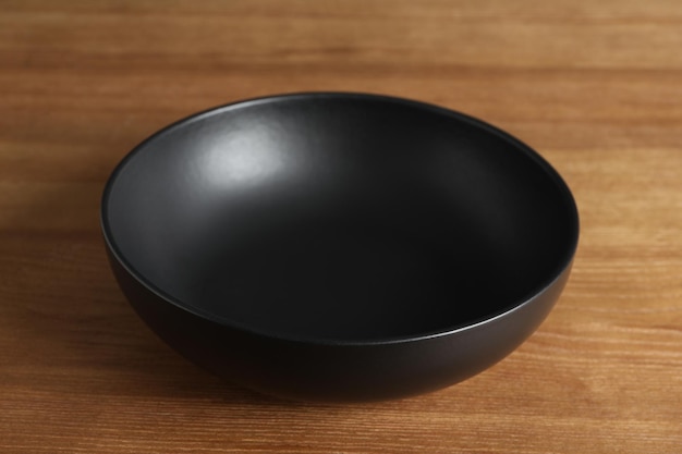 Elegant new empty bowl on wooden table