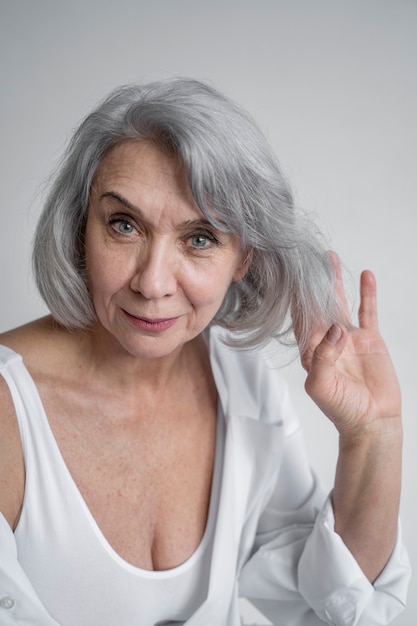 Elegant old woman wearing white clothes