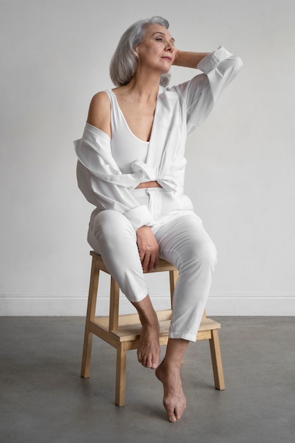 Elegant old woman wearing white clothes