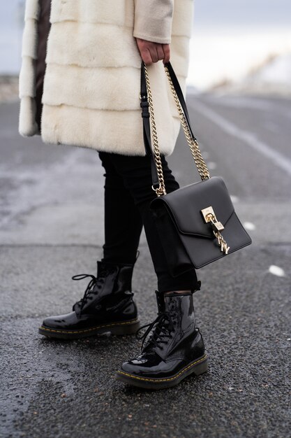 Elegant outfit. Close up of textured big dark bag.