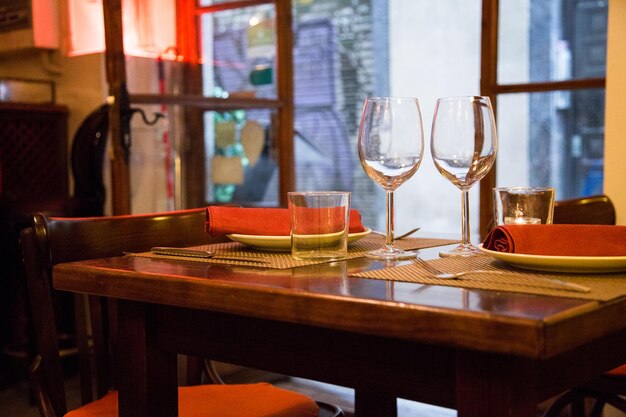 Elegant restaurant table with cutlery, crockery and glasses.