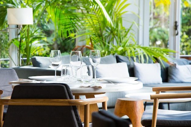 Elegant restaurant table with cutlery, crockery and glasses.