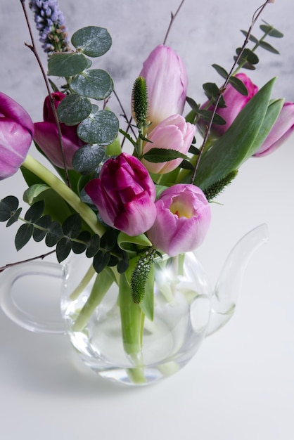 Elegant spring bouquet of tulips in a vase on the table close-up