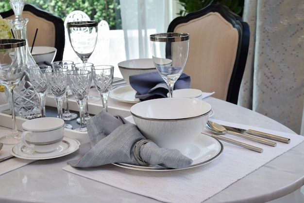 Elegant table set on marble dining table in vintage style dining room interior