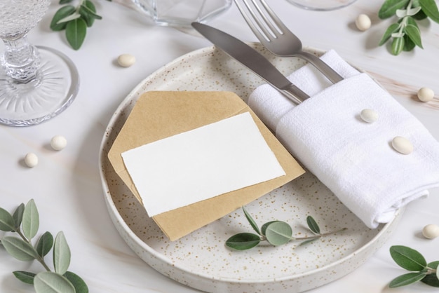 Elegant Table setting with a card decorated with eucalyptus branches close up Wedding mockup