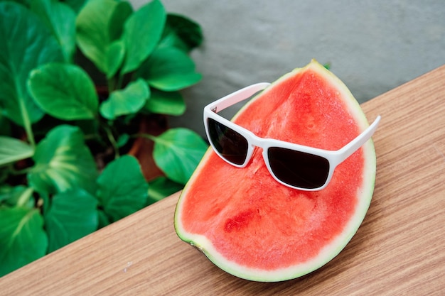 Elegant watermelon with white sunglasses concept of summer healthy living and holidays