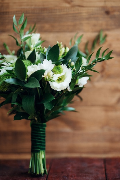 Elegant wedding bouquet of fresh natural flowers and greenery