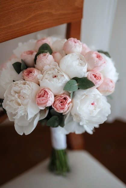 Elegant wedding bouquet of fresh natural flowers and greenery