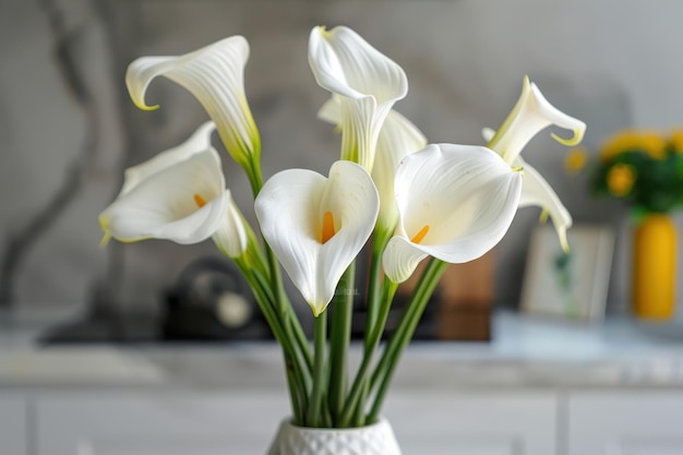 Elegant white calla lilies arranged in a modern vase on a kitchen countertop