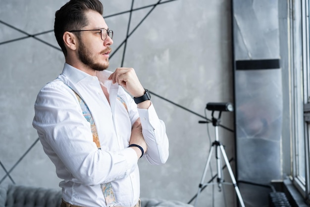 Elegant young handsome man. Good looking young man standing against grey background