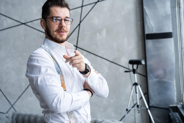 Elegant young handsome man. Good looking young man standing against grey background