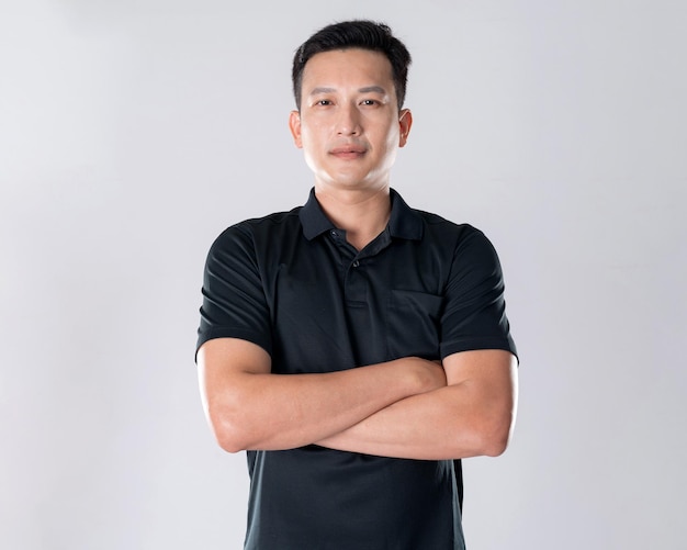 Elegant young man in black shirt standing on white background