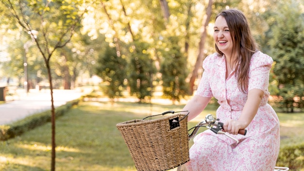 Elegant young woman riding bicycle