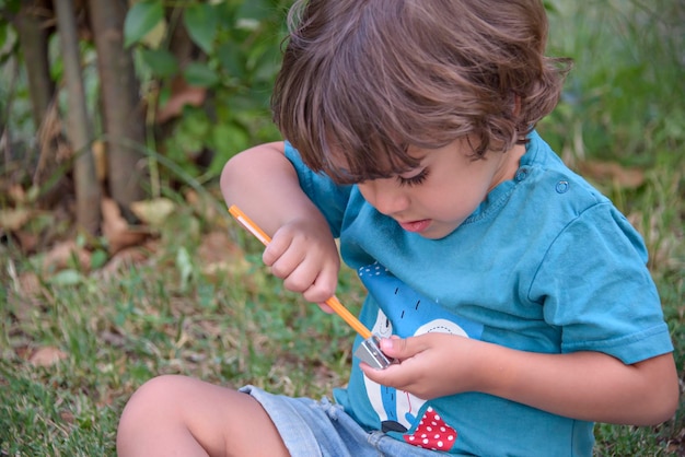 Elementary school age boys love to paint in parks Boys are drawing pictures as an outdoor hobby Concept of education outside of school