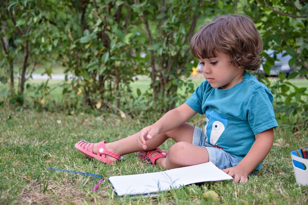 Elementary school age boys love to paint in parks Boys are drawing pictures as an outdoor hobby Concept of education outside of school