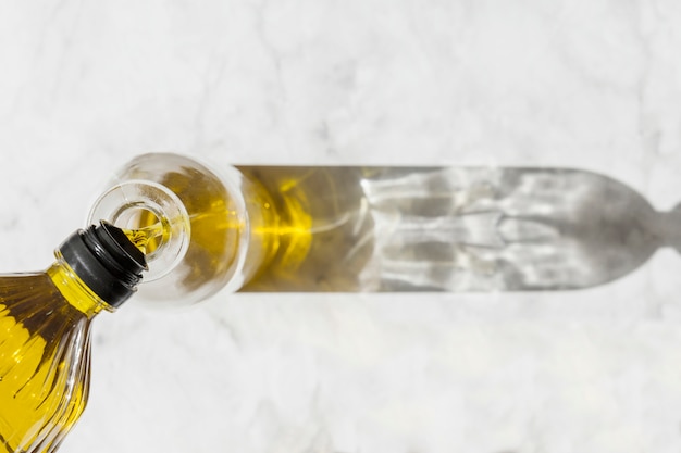 Elevated view of olive poured in the bottle on floor