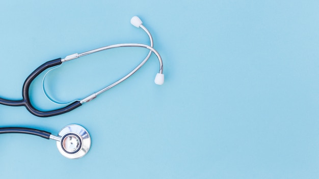 An elevated view of stethoscope over blue background