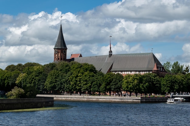 Embankment of river Pregol overlooking island of Kant in city of Kaliningrad Russia Kalingrad keninsberg summer tourism in russia boat on water baltika kant anniversary of kant