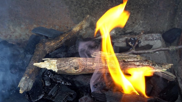 Embers glowing in blazing fire burning charcoal close up view